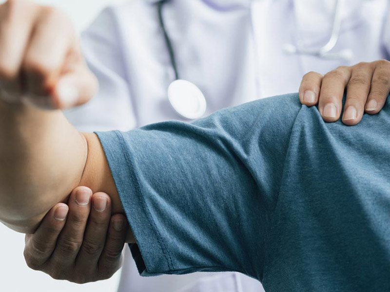 Doctor examining shoulder joint for pain and stiffness